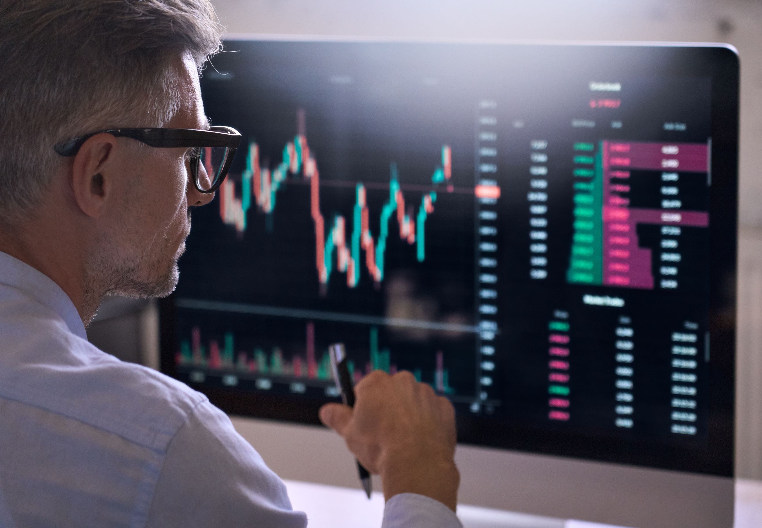 business man reviewing data on large screen