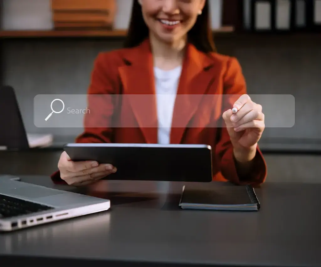 Professional using tablet and stylus with virtual search bar, representing AI-driven enterprise search in retail.