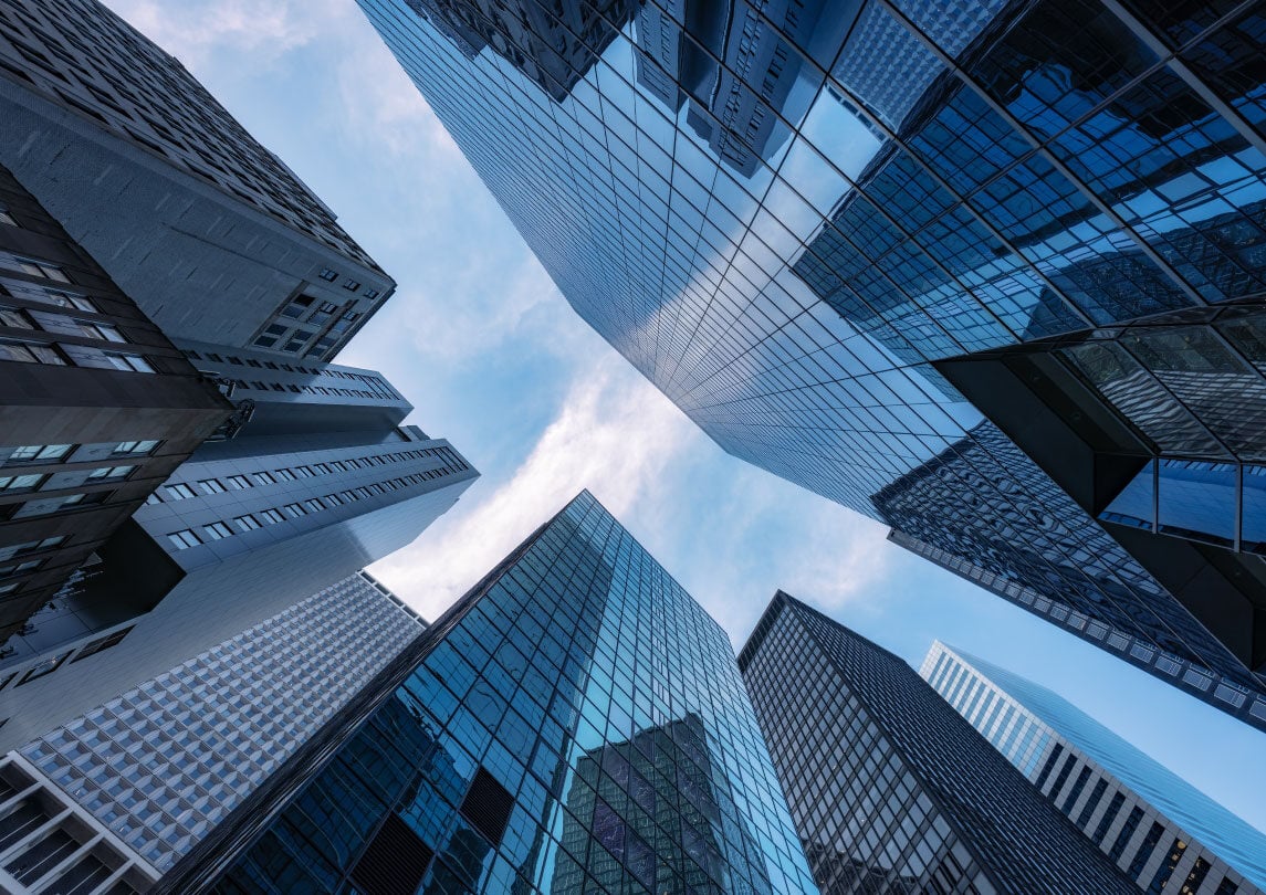 view of sky looking up through gap in skyscrapers