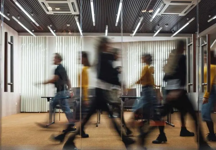 people walking fast on an office