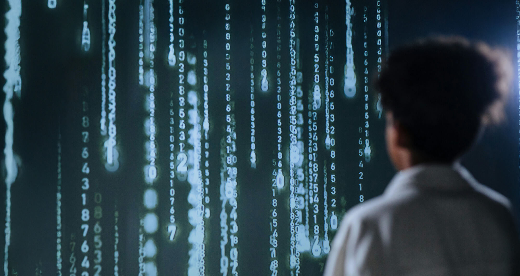 Person analyzing glowing blue data projections, representing AI-driven innovation in financial services.