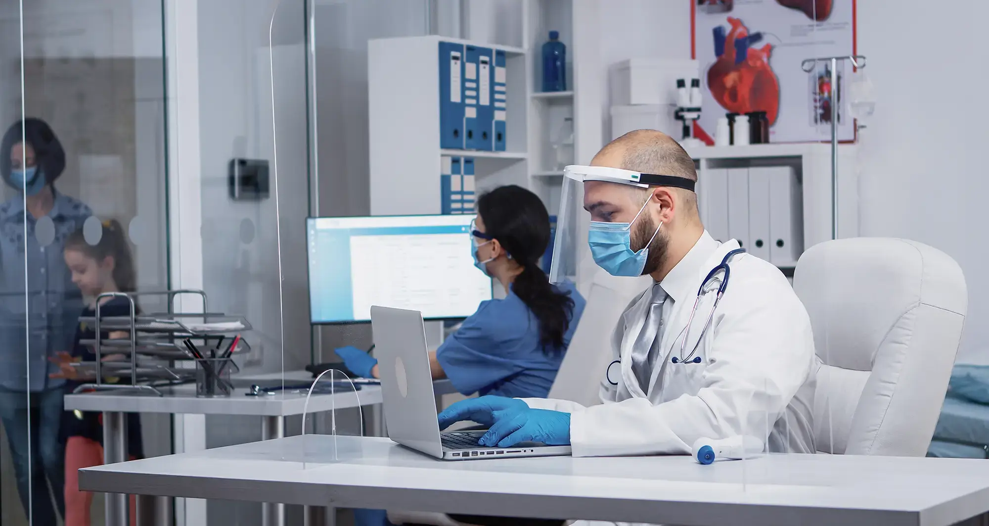 doctor-typing-on-laptop-fullscreen-hero-desktop