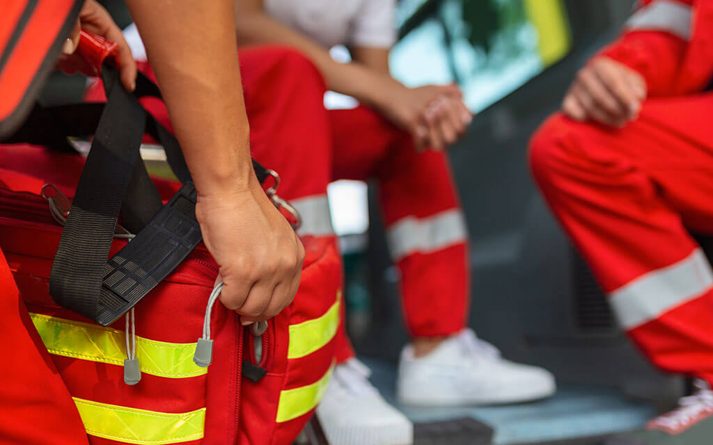 paramedics in the rear of an ambulance getting ready to respond to an emergancy call