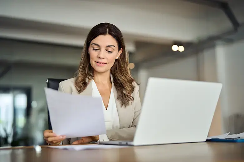 business woman reviewing data on laptop