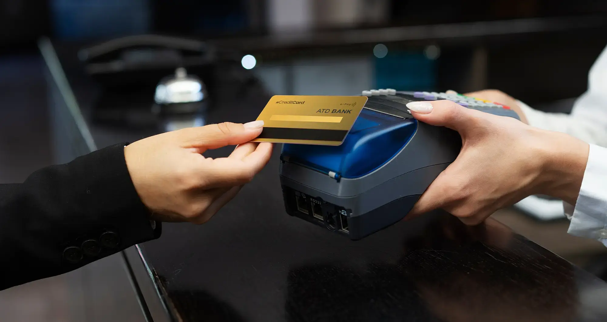 woman taping her gold credit card on hand held payment collection device