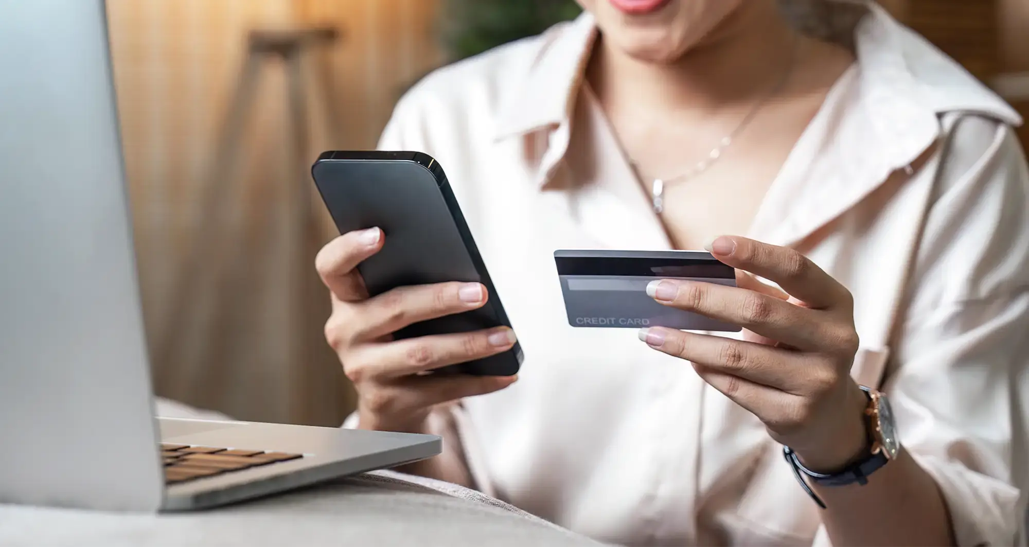 woman-holding-card-phone-closeup-hero