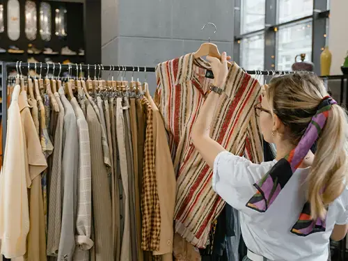 woman-lifting-clothing-hanger-shop-marketing-hero