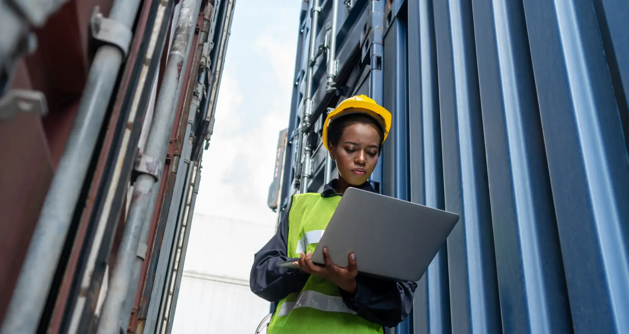 female employee checking computer at mining facility