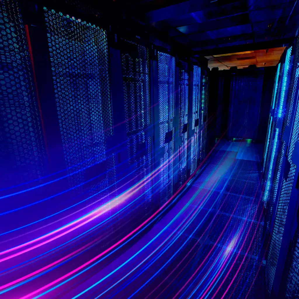 Data center server racks with dynamic light trails representing high-speed data transfer.