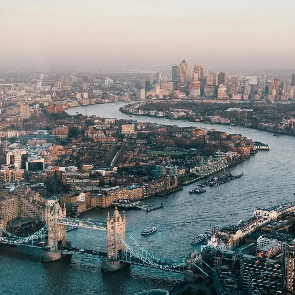 Aerial view of London skyline with Tower Bridge and Canary Wharf, symbolizing financial and technology hubs
