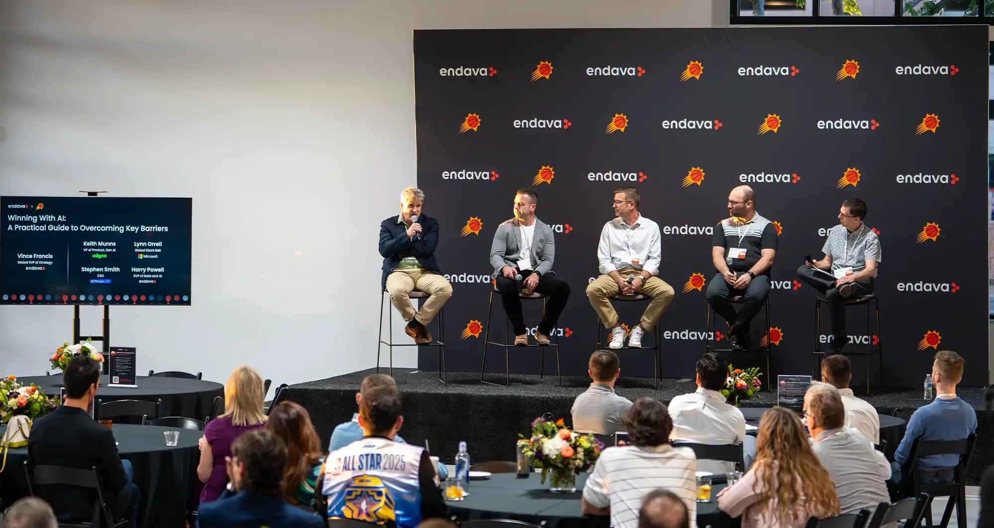 Panel discussion titled “Winning With AI: A Practical Guide to Overcoming Key Barriers” hosted by Endava and Phoenix Suns, with industry leaders speaking on stage to a seated audience.