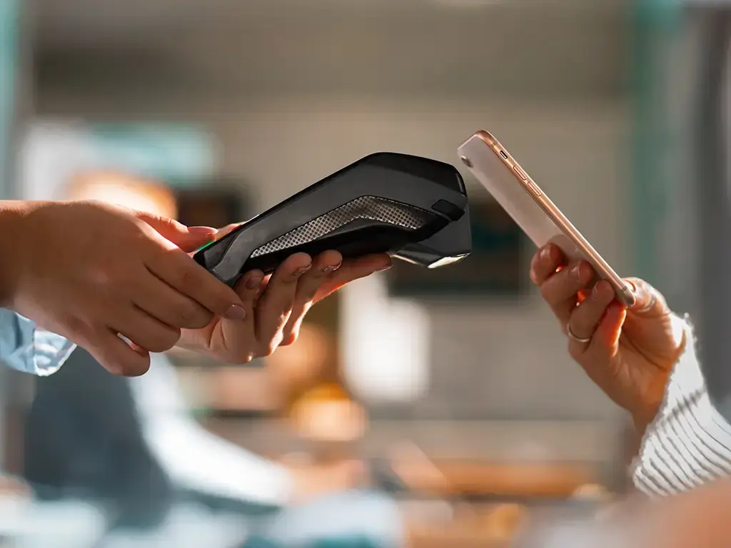 Contactless payment made with smartphone using a wireless point-of-sale terminal.