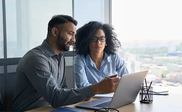 two coworkers reviewing core modernisation report