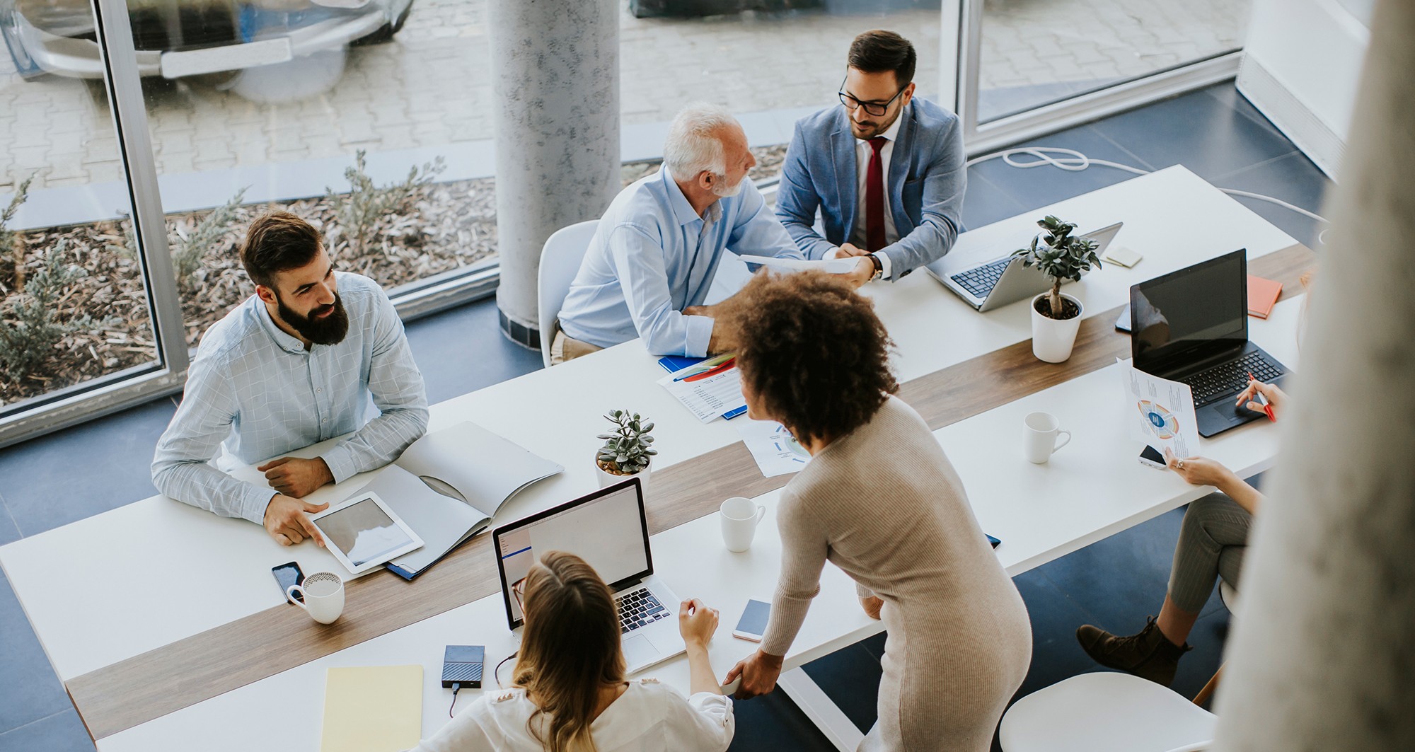 Professionals collaborating in a modern office space, reviewing data and discussing digital strategy.