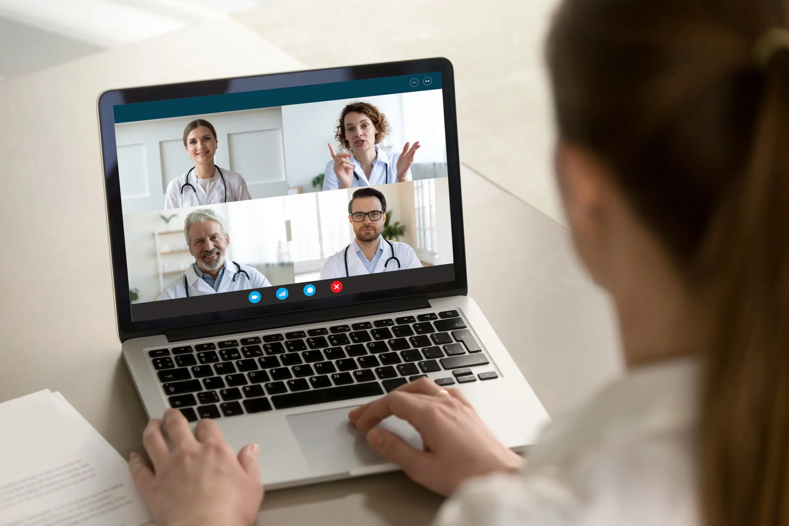 Woman using laptop for video call with doctors, part of a digital health ecosystem