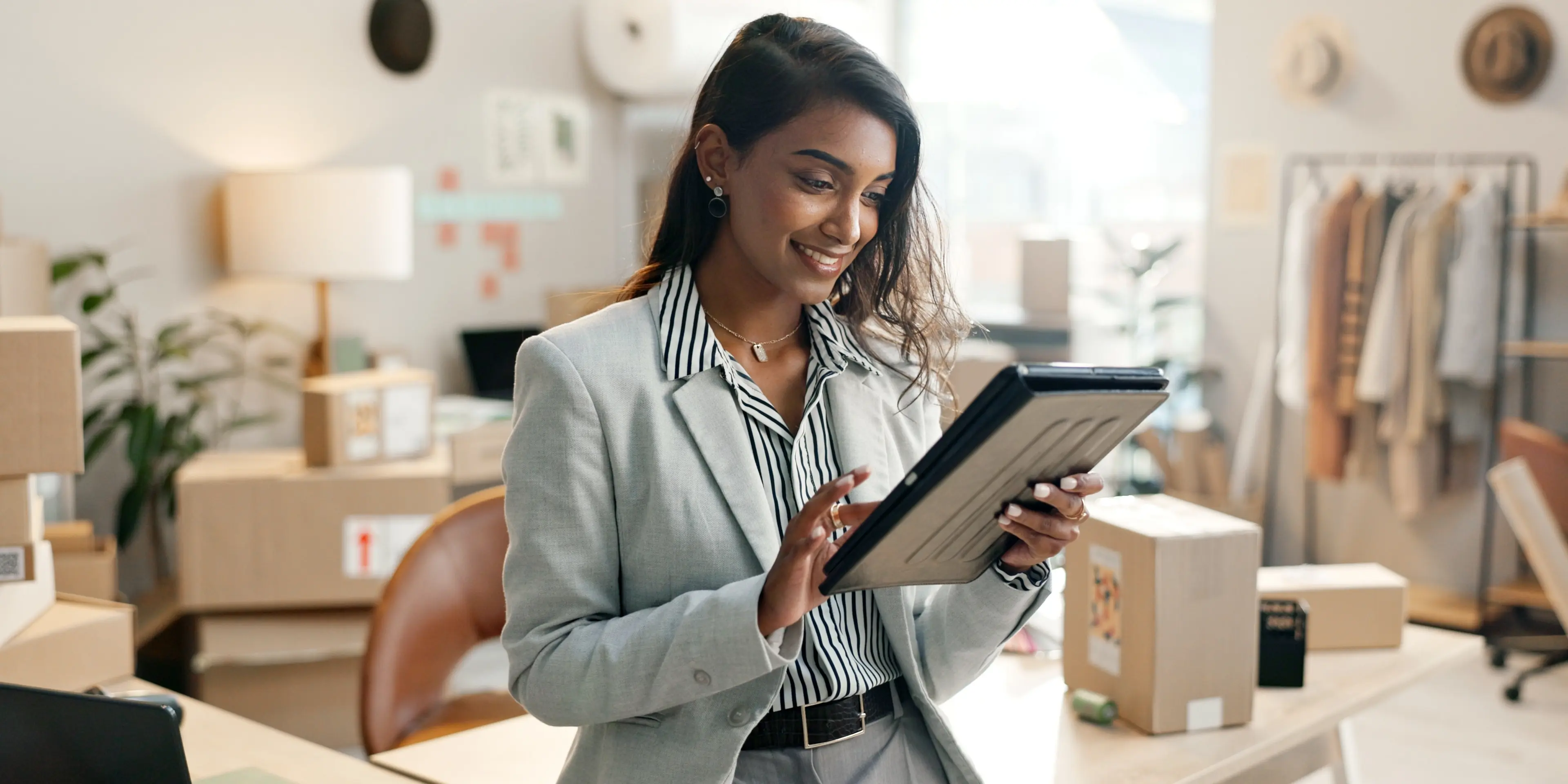 A woman using a modern retail order management system to streamlines operations, improves efficiency, and enhances customer experience.