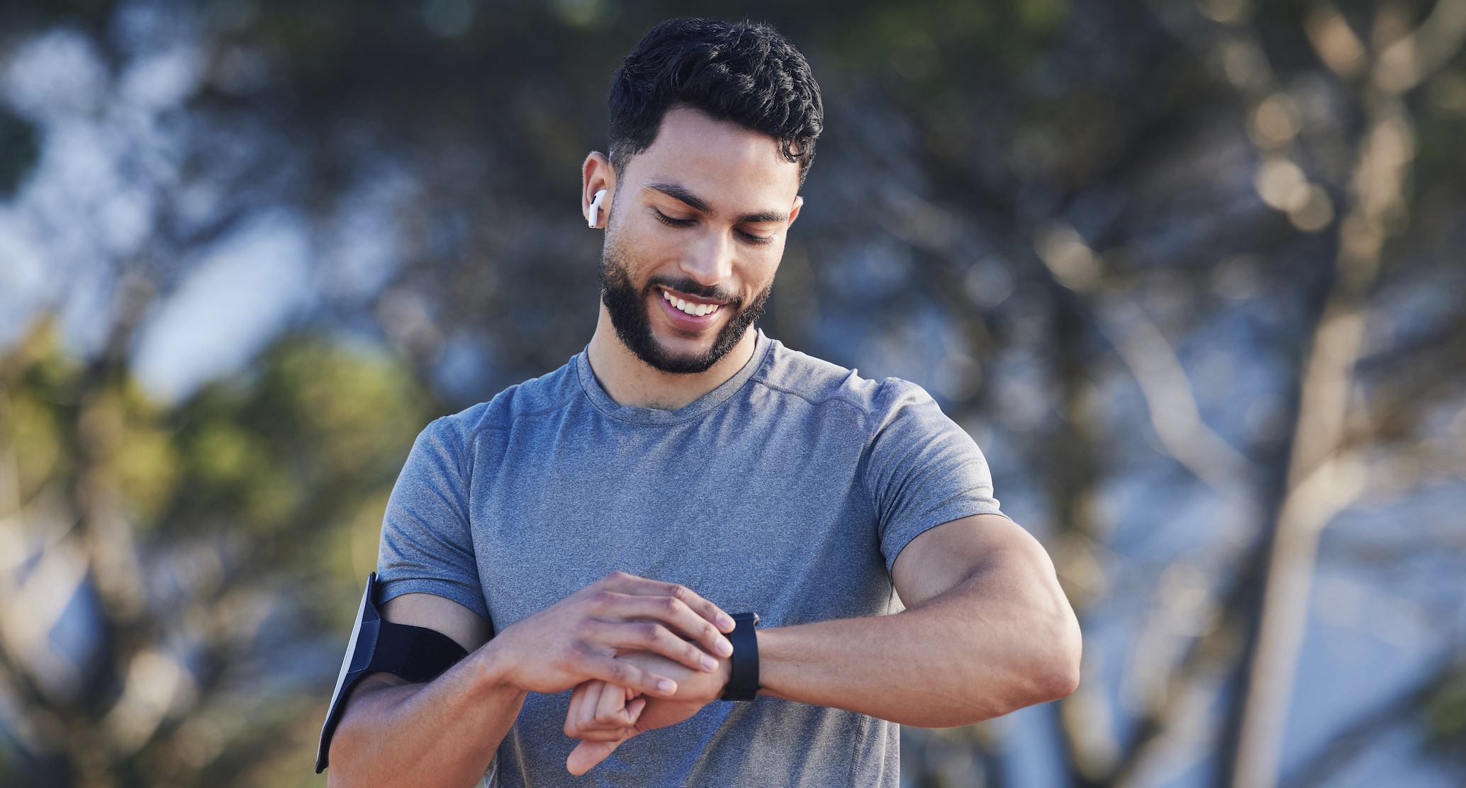 man looking at his watch during workout