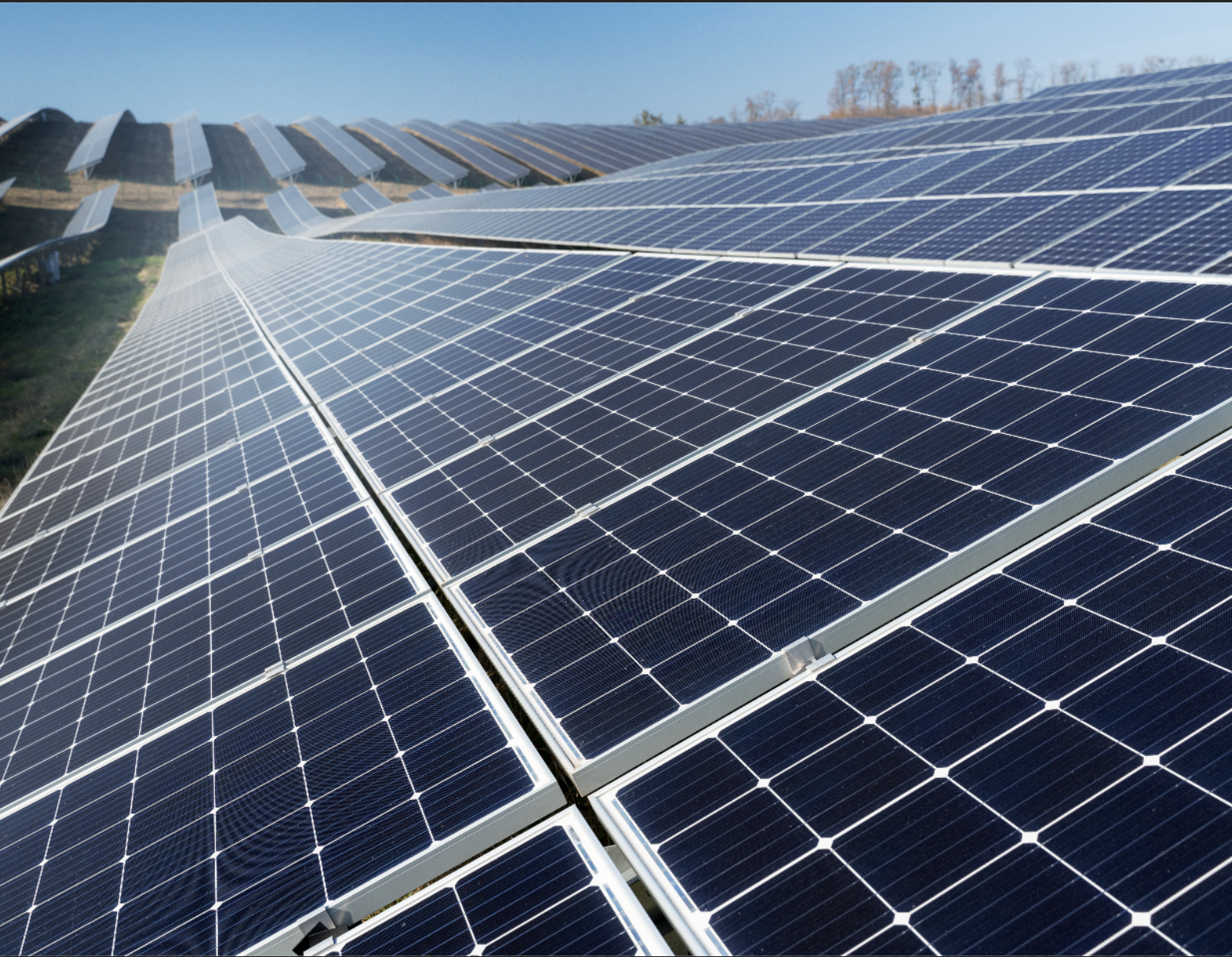 Large field of solar panels extending off into the distance