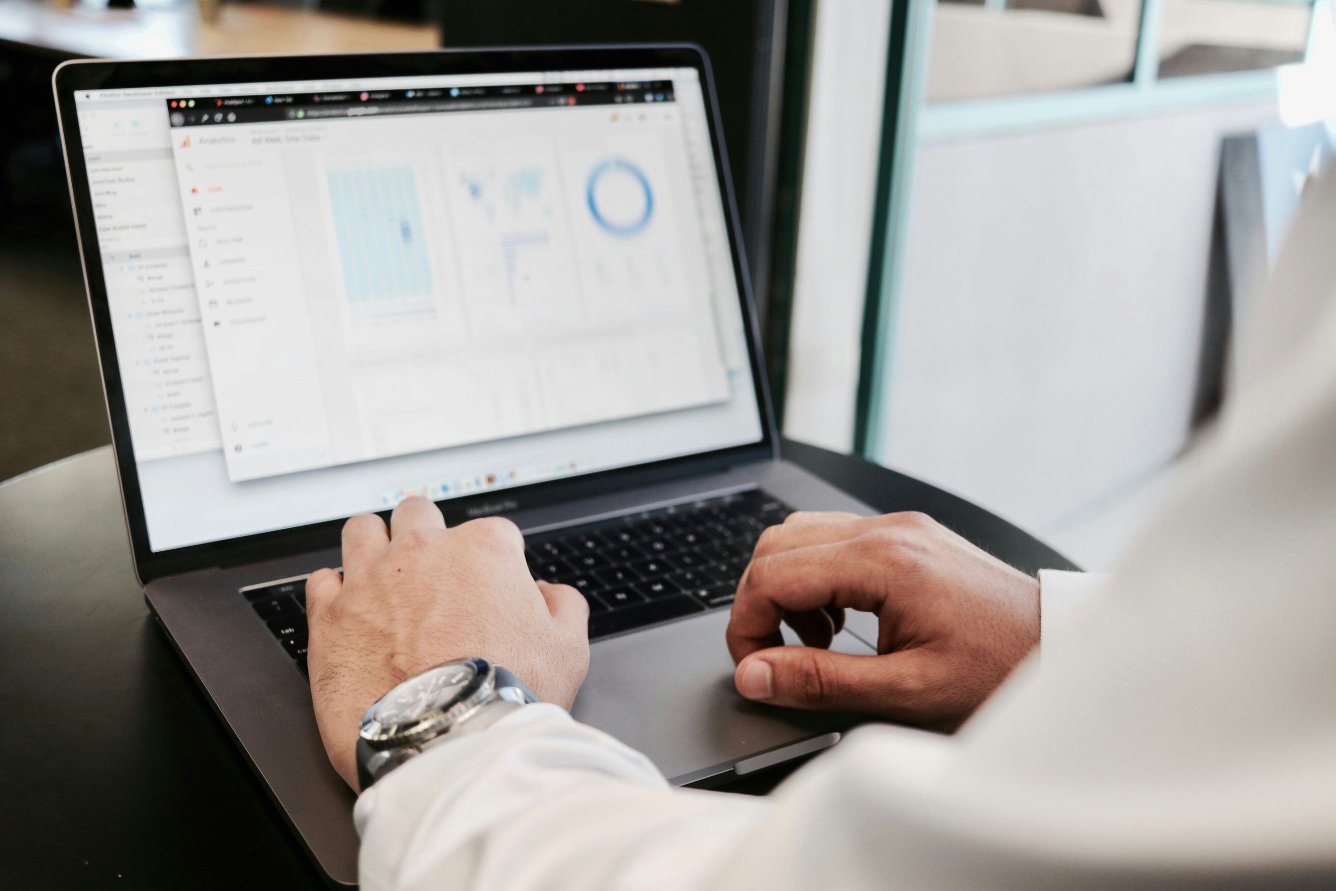 Man working on laptop studying sports and betting data